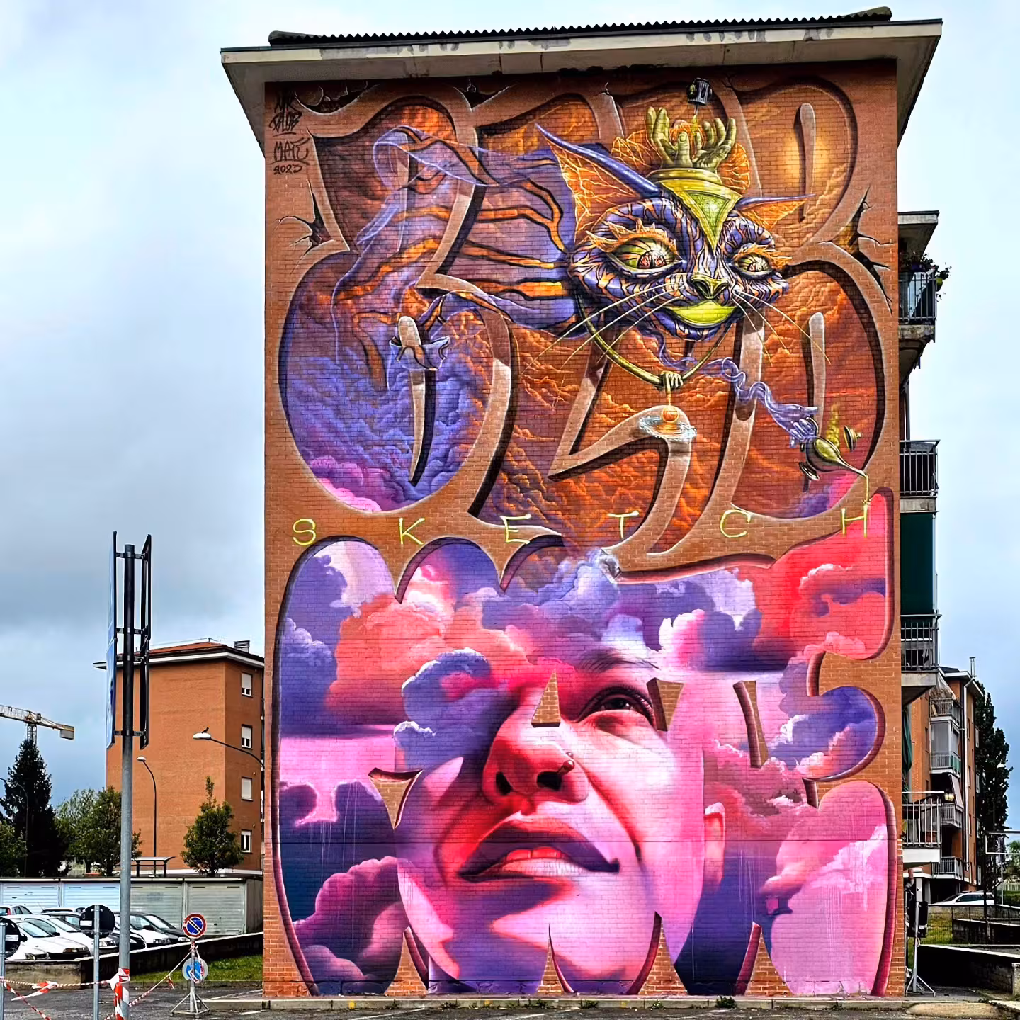 Massive vertical building facade graffiti mural by Mr Blob and Mate for Sketchmate, featuring a realistic female portrait blending with pink clouds and a surreal Cheshire cat interwoven into giant 3D lettering.