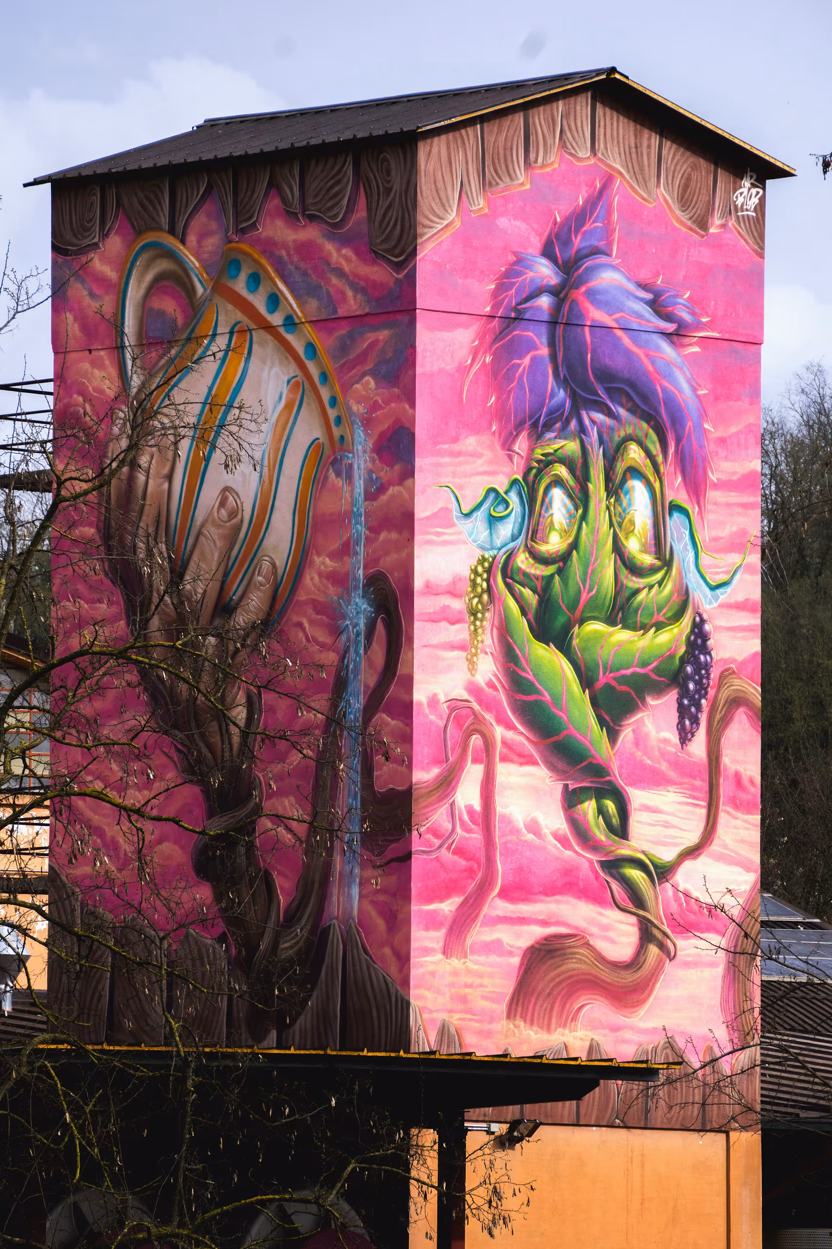 Stunning vertical graffiti mural for an Italian winery by Mr Blob, featuring a surreal anthropomorphic grapevine plant character with purple leaves and grapes against a vibrant pink sky.